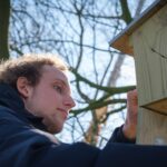 Koen Hiemstra is checking one of the nesting boxes on campus.